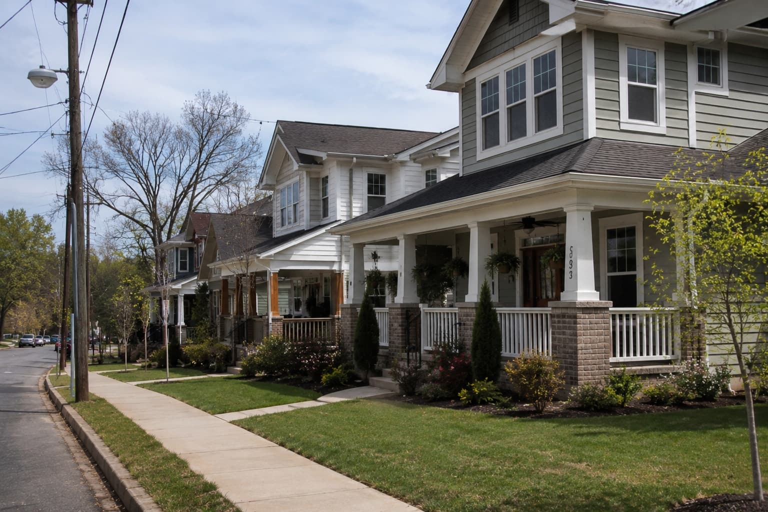 Top Neighborhoods with New Homes for Rent in Atlanta, GA (2026) Modern newly built single-family rental homes in a suburban Atlanta neighborhood with landscaped lawns, sidewalks, and spacious front porches.